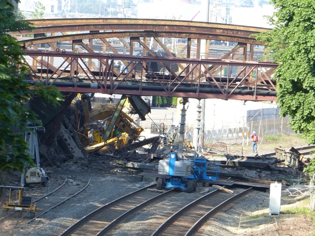 Excavator falls from Boston bridge onto rail track