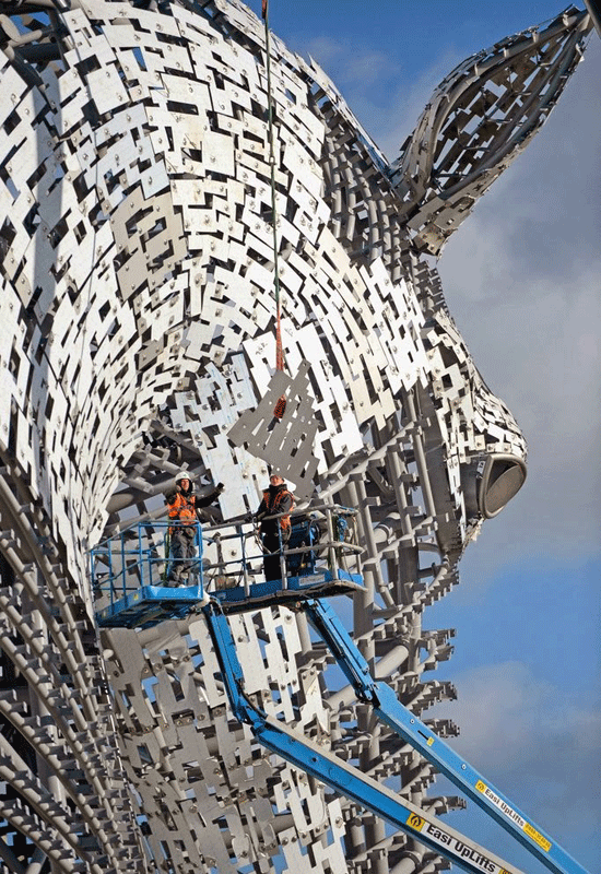 Genie booms help to construct giant horse heads